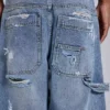 Blå vintage-slitna snickarjeans