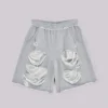 Gråa, slitna Monster-shorts