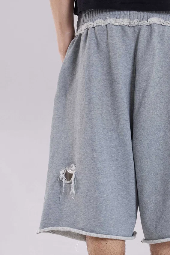 Gråa, slitna Monster-shorts