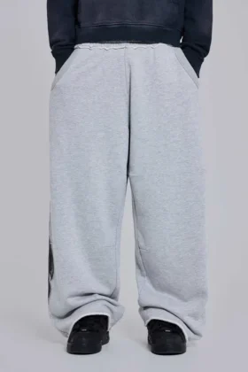 Gråmelerade, baggy Monster Joggers med gotiskt tryck
