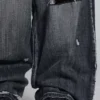 Svarta, slitna XL Colossus Jeans